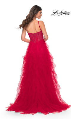 A woman is shown from the back wearing the La Femme Sheer-Waist Long Ruffled Prom Dress 32233, a floor-length red gown with a fitted sheer bodice, thin straps, and layered ruffled tulle for a dramatic silhouette.