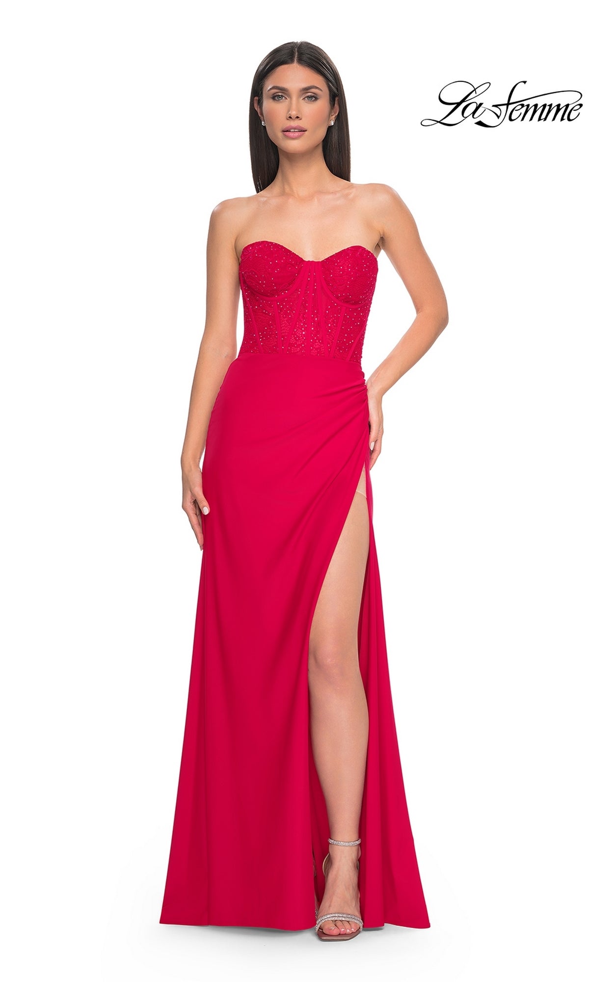 A woman stands against a white background wearing the La Femme Strapless Long Corset Prom Dress 32234 in bright pink, featuring a sparkly embellished bodice and thigh-high slit. The La Femme logo appears in the top right corner.