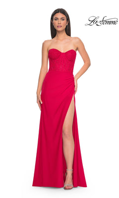 A woman stands against a white background wearing the La Femme Strapless Long Corset Prom Dress 32234 in bright pink, featuring a sparkly embellished bodice and thigh-high slit. The La Femme logo appears in the top right corner.
