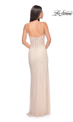A woman models the La Femme Sheer Lace-Bodice Long Prom Dress 32236, a light-colored backless gown with thin straps and an elegant embroidered lace bodice. She faces away from the camera, with the La Femme logo in the top right corner.