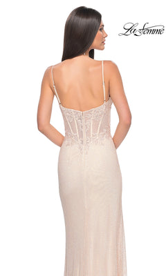 A woman with long straight hair models the La Femme Sheer Lace-Bodice Long Prom Dress 32236, a sleeveless, backless gown with fitted beige embroidered lace and delicate spaghetti straps. The La Femme logo is in the top right corner.