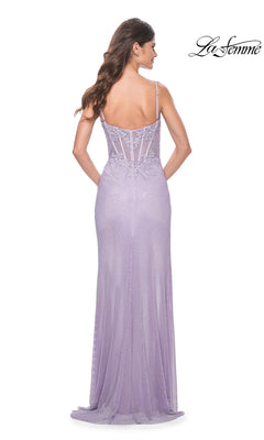 A woman faces away from the camera wearing the La Femme Sheer Lace-Bodice Long Prom Dress 32236—lavender, floor-length with thin straps, embroidered lace bodice, and a fitted sheer back. "La Femme" logo appears top right.