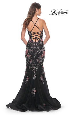 Wearing the La Femme Floral-Lace Long Black Prom Dress 32246, this woman stuns in a mermaid silhouette with pink floral-lace embroidery, an open back with crisscross lace-up straps, and a slight train.