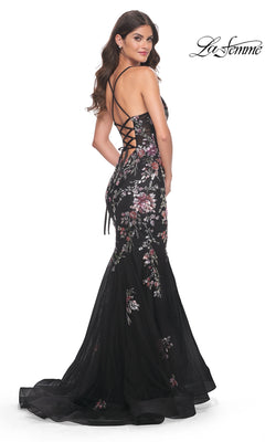 A woman poses looking over her shoulder in the La Femme Floral-Lace Long Black Prom Dress 32246, featuring floral-lace embroidery and a lace-up back. The La Femme logo is displayed in the top right corner.