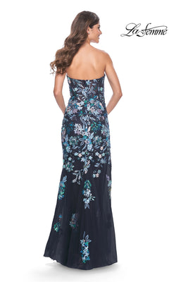 Woman wearing the La Femme Strapless Sequin-Print Prom Dress 32251 with blue and white floral embroidery, shown from the back. This elegant long prom dress offers a stunning silhouette for any special event.