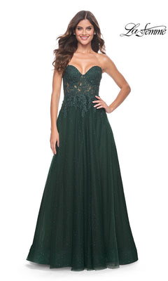 A woman smiles against a white background wearing the La Femme Sheer-Lace Long Beaded Prom Dress 32253, a strapless dark green gown with floral lace details and sparkling embellishments.