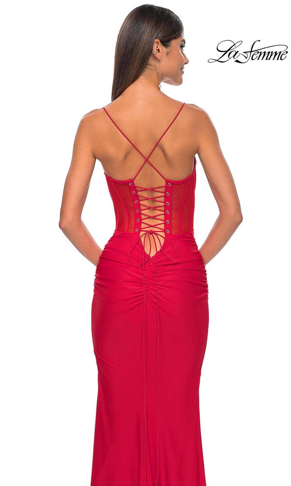 Woman in the La Femme Sheer-Corset Long Prom Dress 32258, featuring a fitted red silhouette, corset-style bodice, lace-up back, and ruched details, shown from the back on a white background.