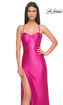 A woman models the La Femme Bright Neon Long Prom Dress 32262, featuring a vivid pink satin finish, thin straps, corset-style bodice, and high slit, standing against a white background with the La Femme logo in the top right corner.