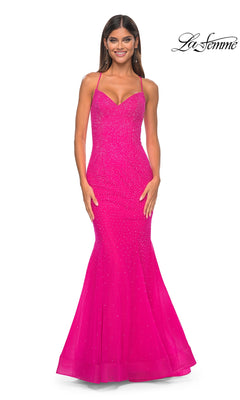 A woman smiles in the La Femme Embellished Long Mermaid Prom Dress 32273, a hot fuchsia, floor-length gown with thin straps and subtle sparkle. The La Femme logo appears in the top right corner.