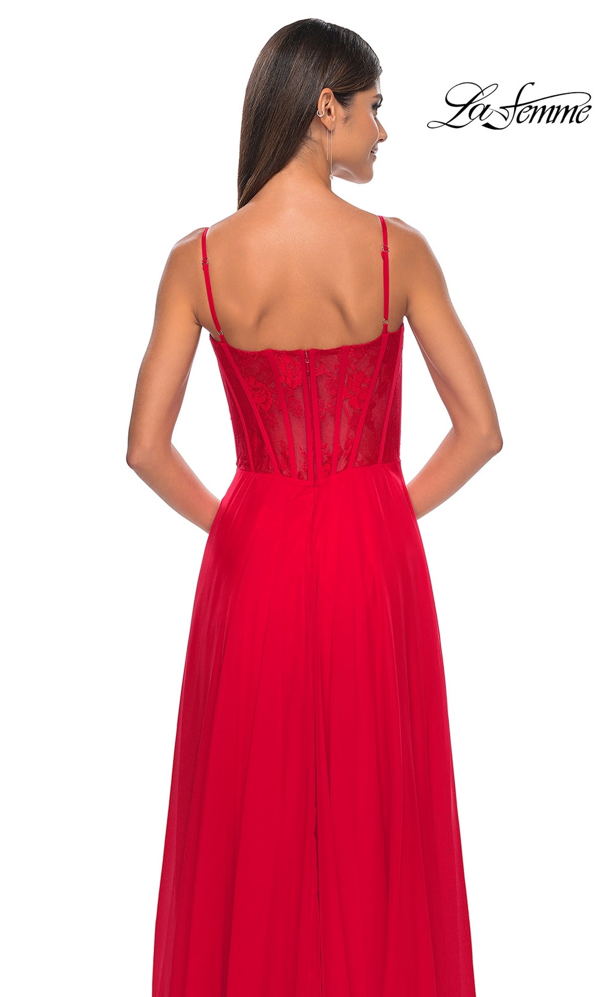 A woman in the La Femme Long Chiffon Sweetheart Prom Dress 32276, a red sleeveless formal gown with a floral-lace sweetheart bodice and lace back detail, stands against a white background.