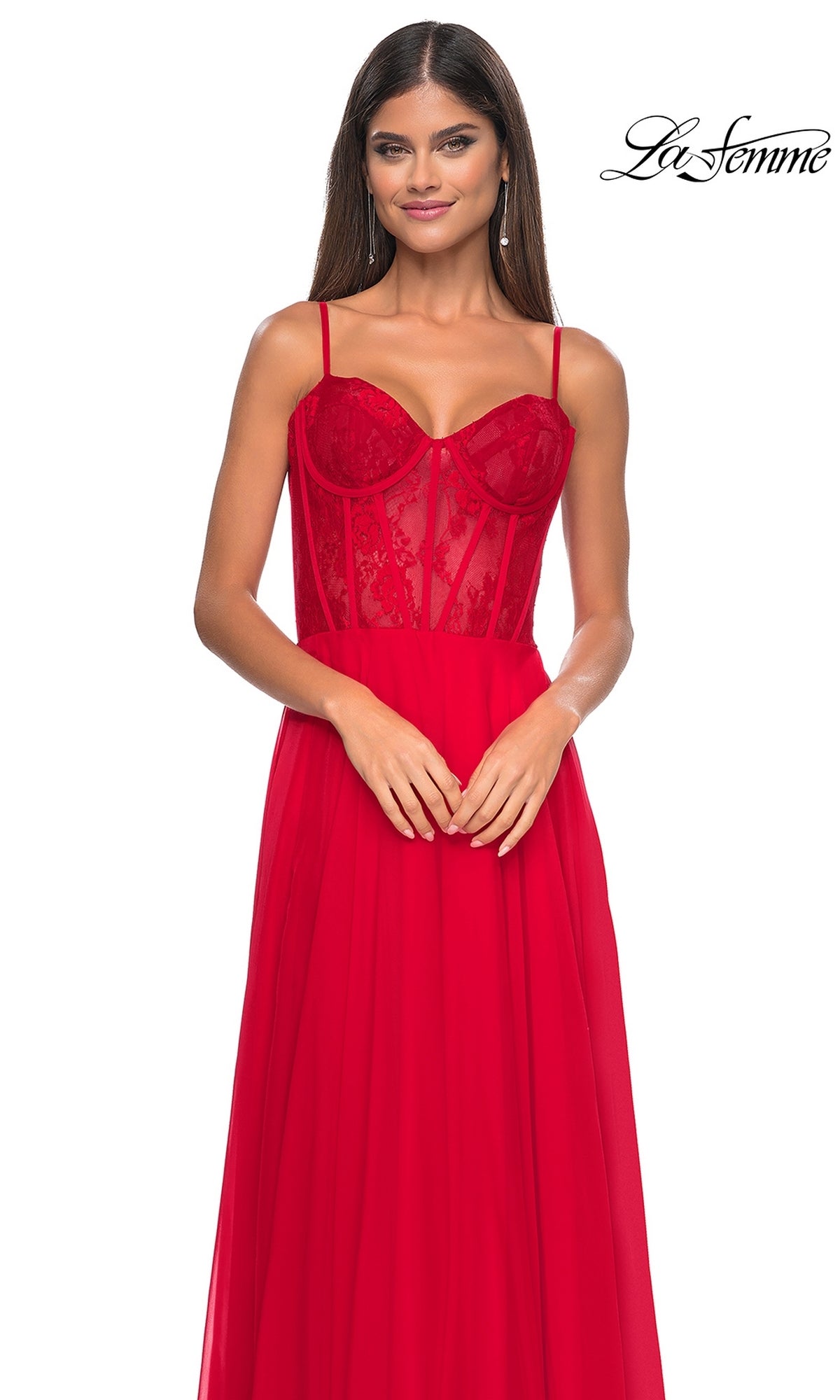 A woman models the La Femme Long Chiffon Sweetheart Prom Dress 32276 in red, featuring a floral-lace bodice and spaghetti straps, standing against a white background with the 