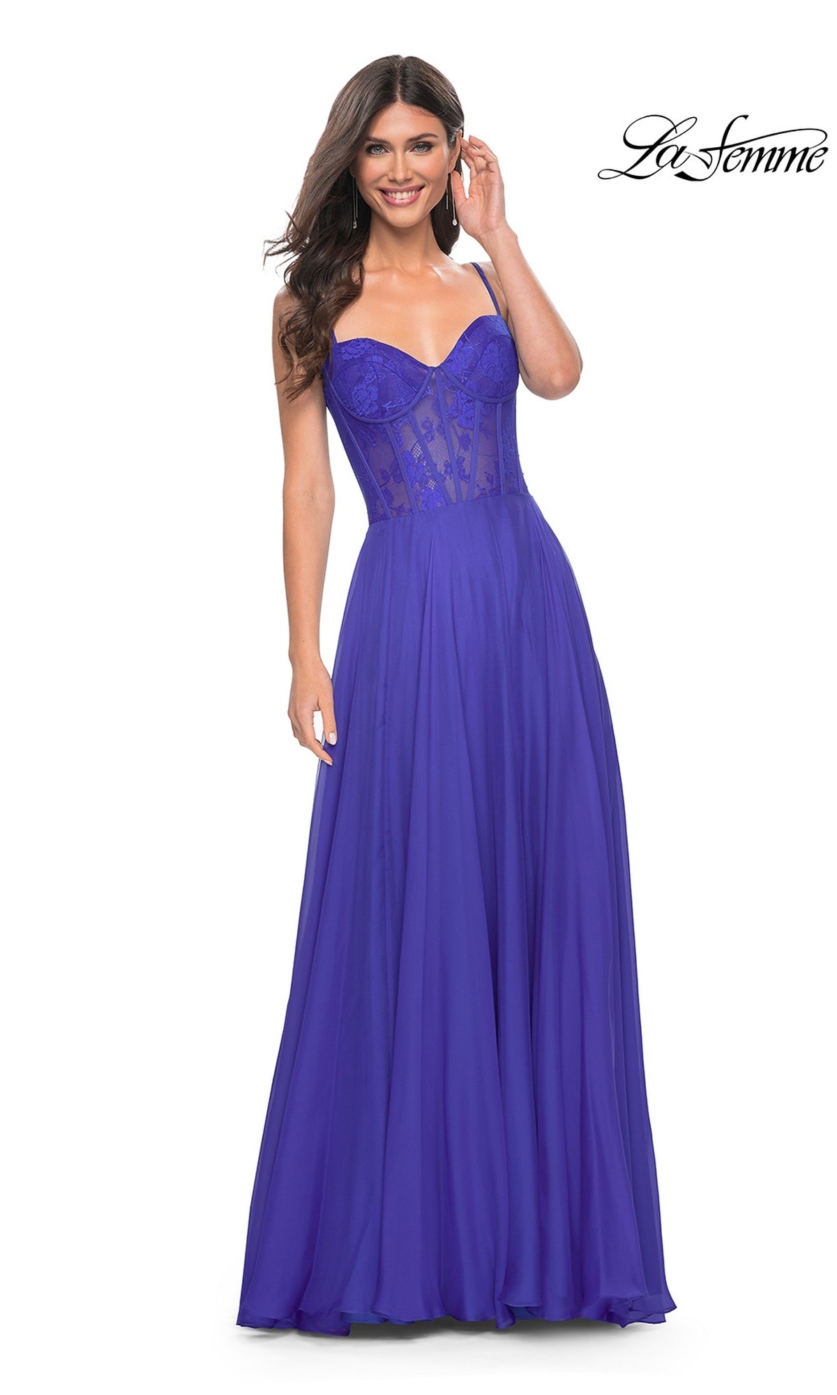 A woman models the La Femme Long Chiffon Sweetheart Prom Dress 32276 in royal blue, with a fitted semi-sheer floral-lace bodice and flowing skirt. The “La Femme” logo appears in the top right corner.