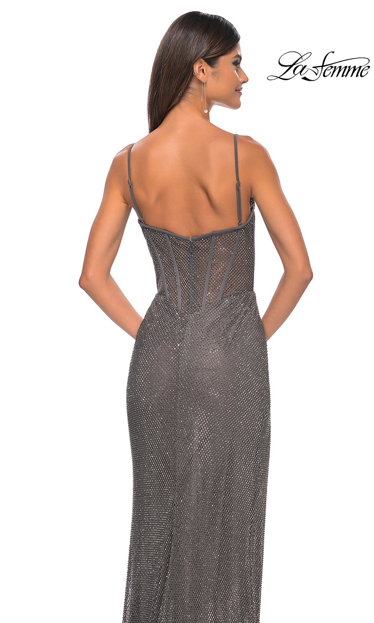 Woman wearing the La Femme Sheer-Waist Long Beaded Prom Dress 32285, a sleeveless fitted gown with thin straps and a low back, photographed from behind against a white background.