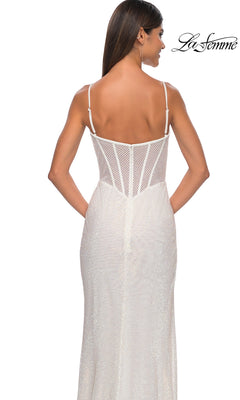 Woman in a fitted white La Femme Sheer-Waist Long Beaded Prom Dress 32285 with thin straps and semi-sheer mesh bodice, shown from the back against a white background.