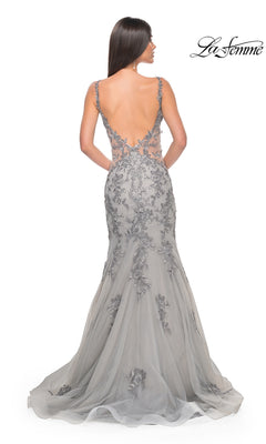 A woman faces away, wearing the La Femme Backless Long Mermaid Prom Dress 32295 in gray with lace applique and a floor-length backless design. The "La Femme" logo appears in the top right corner.