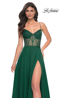 Woman wearing the La Femme Sheer-Waist Long A-Line Prom Dress 32296 in dark green, featuring a sheer corset bodice, thin straps, and high thigh slit, posing against a white background.