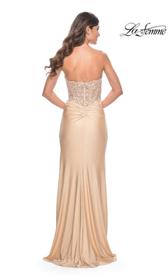 A woman is shown from the back wearing the La Femme Strapless Long Pleated Prom Dress 32301 with a strapless floral-lace bodice, floor-length champagne skirt, and subtle embellishments. The La Femme logo appears in the top right corner.