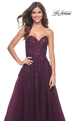 A woman smiles and poses against a white background with the "La Femme" logo, wearing the La Femme Lace-Up Long Sweetheart Prom Dress 32304—a strapless gown with dark purple embroidery.