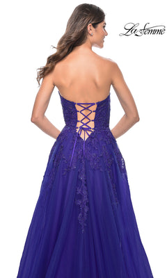 A woman shown from behind in the La Femme Lace-Up Long Sweetheart Prom Dress 32304, a strapless purple gown with floral embroidery and a lace-up back.