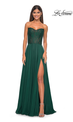 A woman poses and smiles in the La Femme Lace-Bodice Long A-Line Prom Dress 32311, which features a strapless beaded dark green corset bodice and high slit, against a white background. The "La Femme" logo appears in the top right corner.