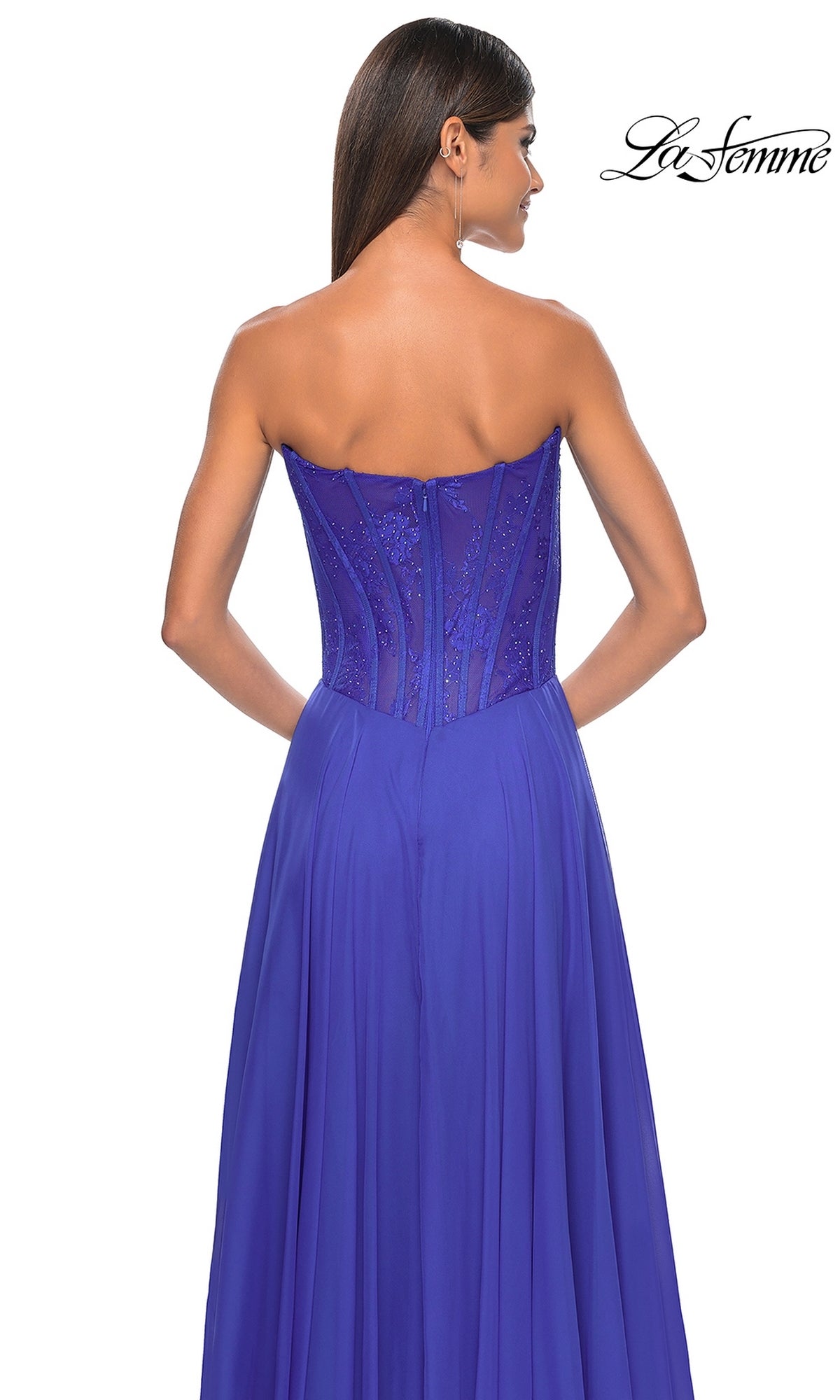Woman models the La Femme Lace-Bodice Long A-Line Prom Dress 32311 in royal blue, featuring a strapless fitted textured bodice and flowing skirt, shown from the back. 
