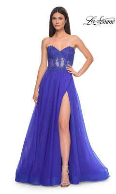 A woman models the La Femme Sheer-Waist Long A-Line Prom Dress 32313, featuring a strapless royal blue design with a high slit, beaded lace bodice, sheer accents, and subtle embellishments against a white background.