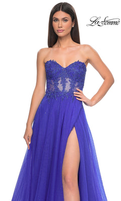 A woman models the La Femme Sheer-Waist Long A-Line Prom Dress 32313, featuring a strapless royal blue gown with beaded lace bodice and high slit, against a white background. "La Femme" appears in the upper right corner.