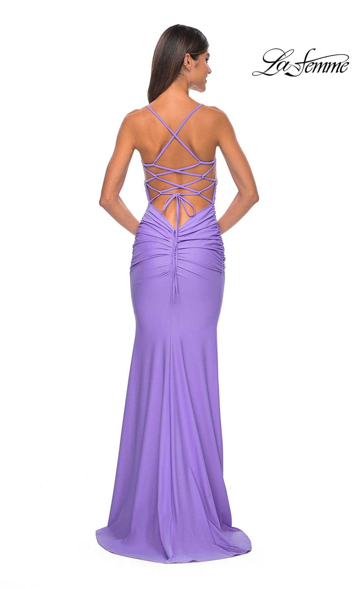 Woman in the La Femme Embellished-Bodice Long Prom Dress 32320, a floor-length lavender gown with a sleeveless design, lace-up open back, and ruched details, standing against a white background.