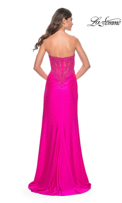 Model showcases the La Femme Strapless Hot Pink Long Prom Dress 32329, featuring beaded detailing and a lace-up back, viewed from behind.