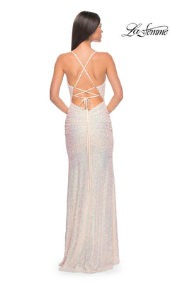 A woman stands facing away in the La Femme Tight Long Sequin Prom Dress 32331, a sparkling floor-length gown with an open crisscross lace-up back. "La Femme" logo appears in the upper right corner.