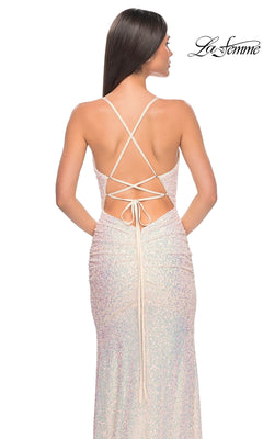 A woman stands with her back to the camera, wearing the La Femme Tight Long Sequin Prom Dress 32331 featuring a shimmering, backless design with crisscross straps and lace-up detail. The "La Femme" logo is in the top right corner.