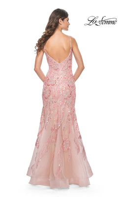 Woman wearing the Le Femme Long Sequin-Lace Prom Dress 32333 in pink, a floor-length mermaid gown with thin straps and sequin embellishments, shown from the back.