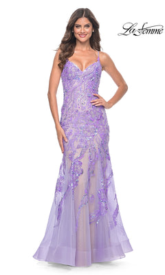 A woman wears the Le Femme Long Sequin-Lace Prom Dress 32333, a lavender floor-length gown with beaded and sequin embellishments, thin straps, and a fitted bodice. The "La Femme" logo appears in the top right corner.