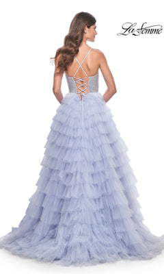 A woman stands facing away in the La Femme Long Tiered A-Line Prom Dress 32335, a lavender gown with a lace-up open back and beaded sweetheart corset detail. The "La Femme" logo is in the top right corner.