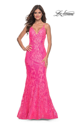 Woman wearing the La Femme Long Sequin Mermaid Prom Dress 32337—fitted, bright pink with thin straps and sequin detailing—standing against a white background.
