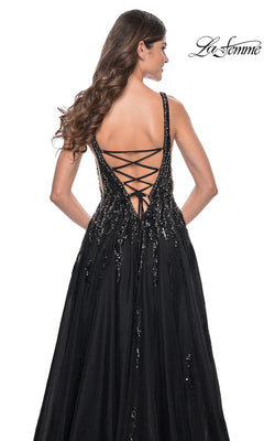 Woman facing away, wearing the La Femme Deep V-Neck Long Black Prom Dress 32345 with sequin-print and lace-up back; "La Femme" prom dress logo is visible in the top right corner.