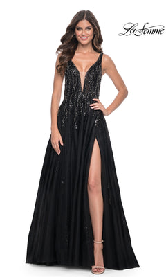A woman models the La Femme Deep V-Neck Long Black Prom Dress 32345, featuring sequin embellishments and a high slit, standing against a plain white background.