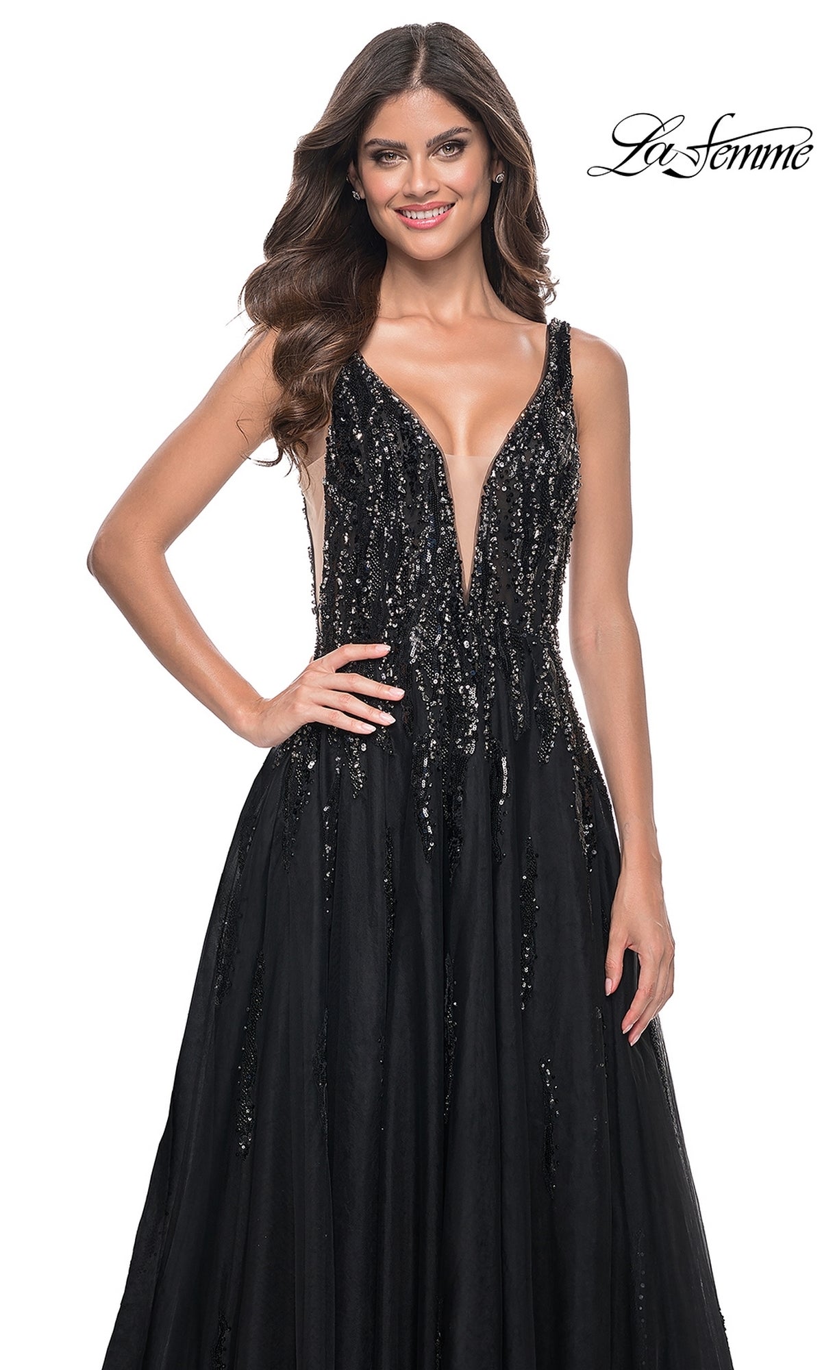 A woman models the La Femme Deep V-Neck Long Black Prom Dress 32345, featuring a sleeveless design and sequin embellishments, smiling against a white background with the 