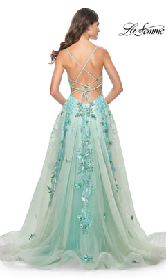A woman wearing the La Femme Sequin-Print Long Green Prom Dress 32347, featuring a long A-line silhouette and lace-up straps, stands with her back to the camera.