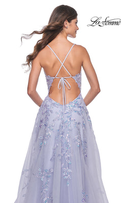 A woman wearing the La Femme Long Periwinkle A-Line Prom Dress 32349 with floral embroidery and a strappy back stands facing away from the camera.