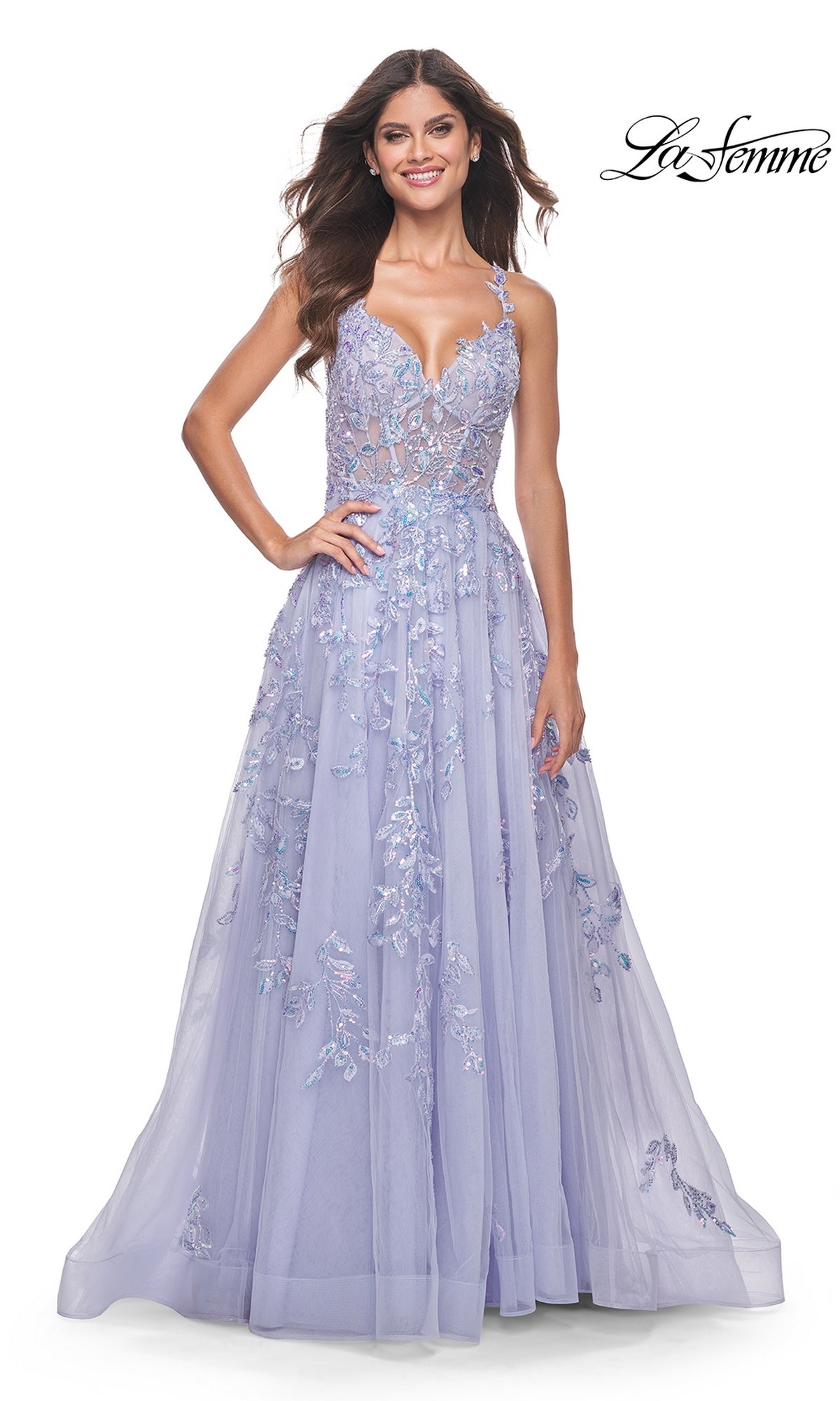 A woman stands smiling in the La Femme Long Periwinkle A-Line Prom Dress 32349, featuring sequin-lace embroidery, a fitted bodice, and flowing skirt. The 
