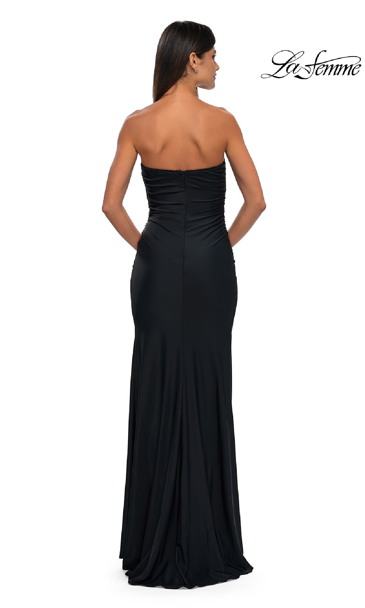 A woman faces away wearing the Simple Strapless Long Prom Dress: La Femme 32360, floor-length and elegant; 