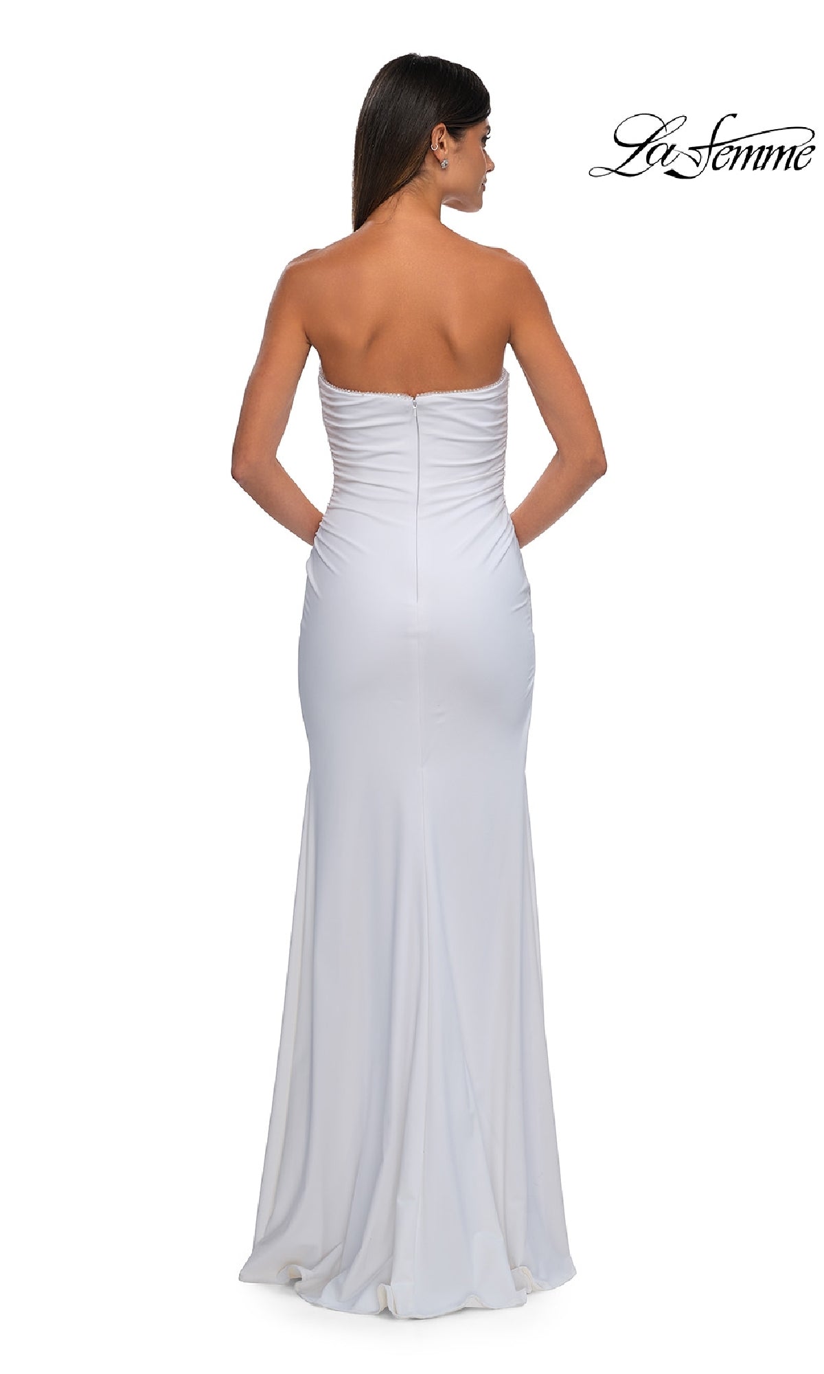 A woman models the La Femme 32360, a simple strapless long prom dress with slight ruching at the top, floor-length fit, and an elegant back design. 