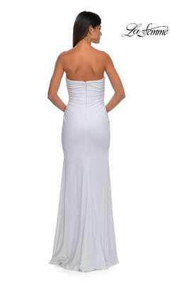 A woman models the La Femme 32360, a simple strapless long prom dress with slight ruching at the top, floor-length fit, and an elegant back design. "La Femme" logo is displayed in the top right corner.