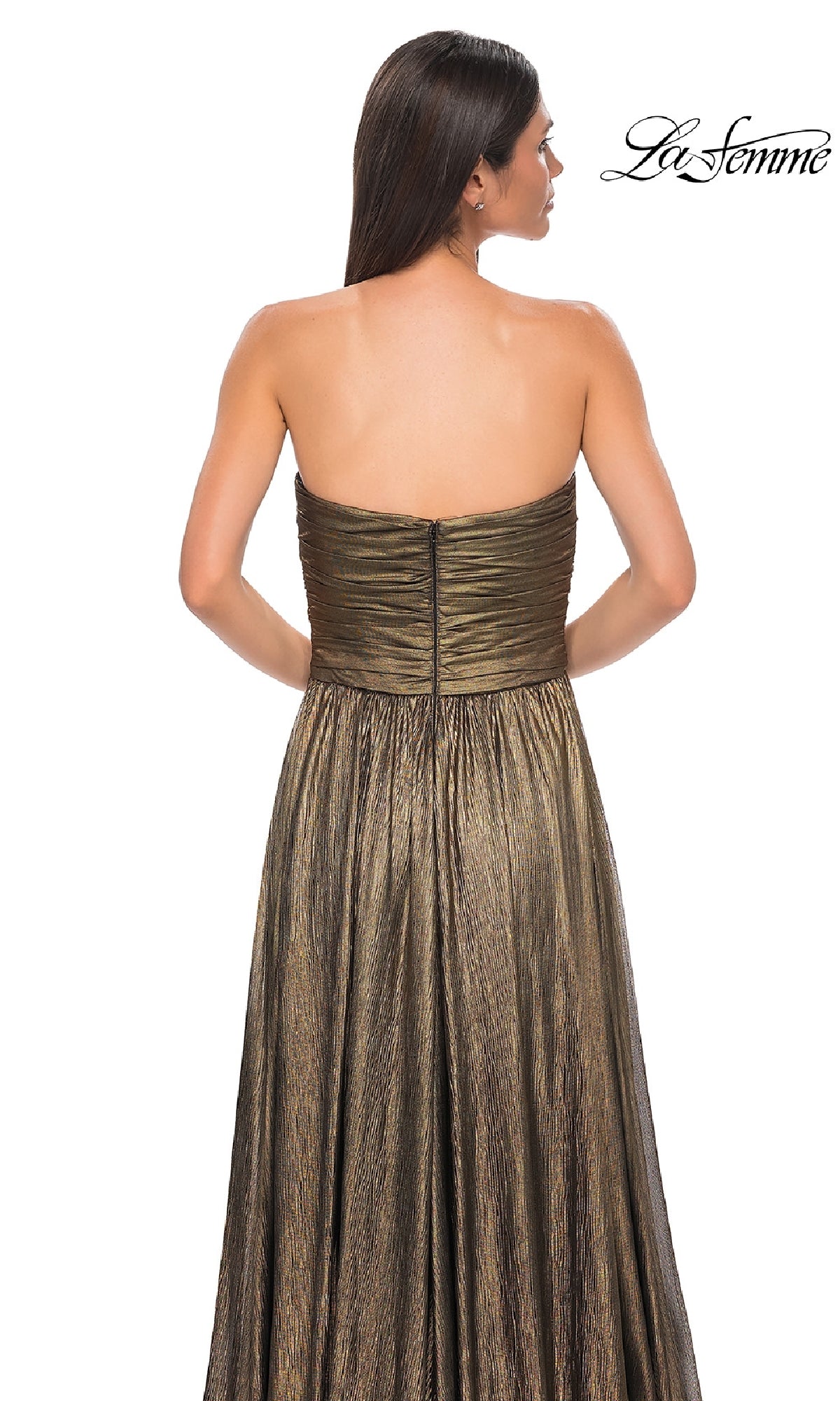 A woman with long brown hair is seen from the back wearing La Femme 32382, a strapless long metallic prom dress with a ruched bodice. The La Femme logo is displayed in the top right corner.