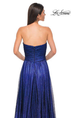 A woman wearing the La Femme 32382 strapless long metallic prom dress stands with her back to the camera against a white background, showcasing the evening gown’s zippered back. The La Femme logo appears in the corner.