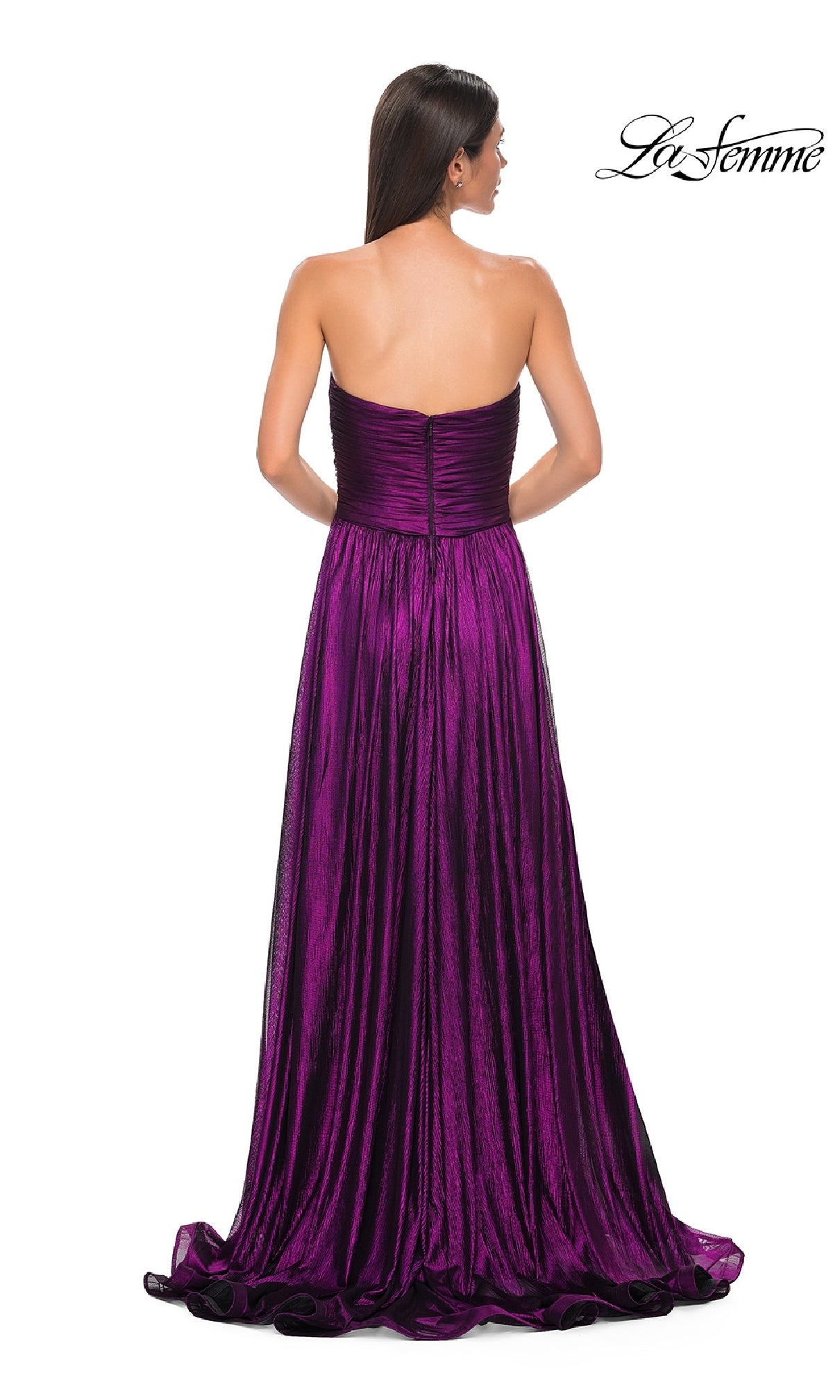 A woman with long brown hair models the La Femme 32382 strapless, floor-length metallic prom dress with a fitted bodice and slight train, shown from the back. The La Femme logo is in the upper right corner.