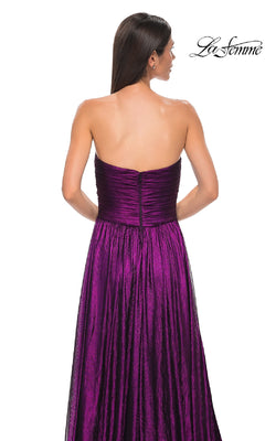 A woman with long dark hair is seen from behind wearing the La Femme 32382, a strapless long metallic prom dress with a fitted bodice and flowing skirt. The "La Femme" logo appears in the top right corner.