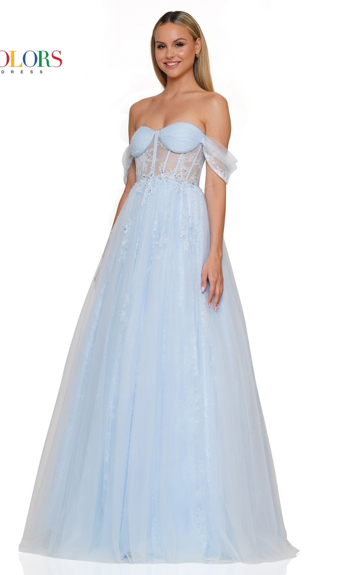 A woman wearing the Long Sweetheart Prom Ball Gown (Colors Dress 3240) in light blue, featuring an off-the-shoulder neckline, sheer panels, and a tulle floor-length a-line skirt, stands smiling at the camera.