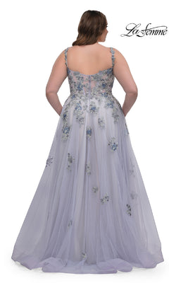 A woman is shown from the back wearing the La Femme 32412 Long Plus-Size Prom Ball Gown, a light lavender dress with floral appliqués, a sheer overlay, thin straps, corset bodice, and delicate lace embroidery for an elegant look.